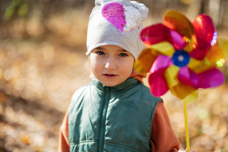 Kindergarten child posing outside in autumn