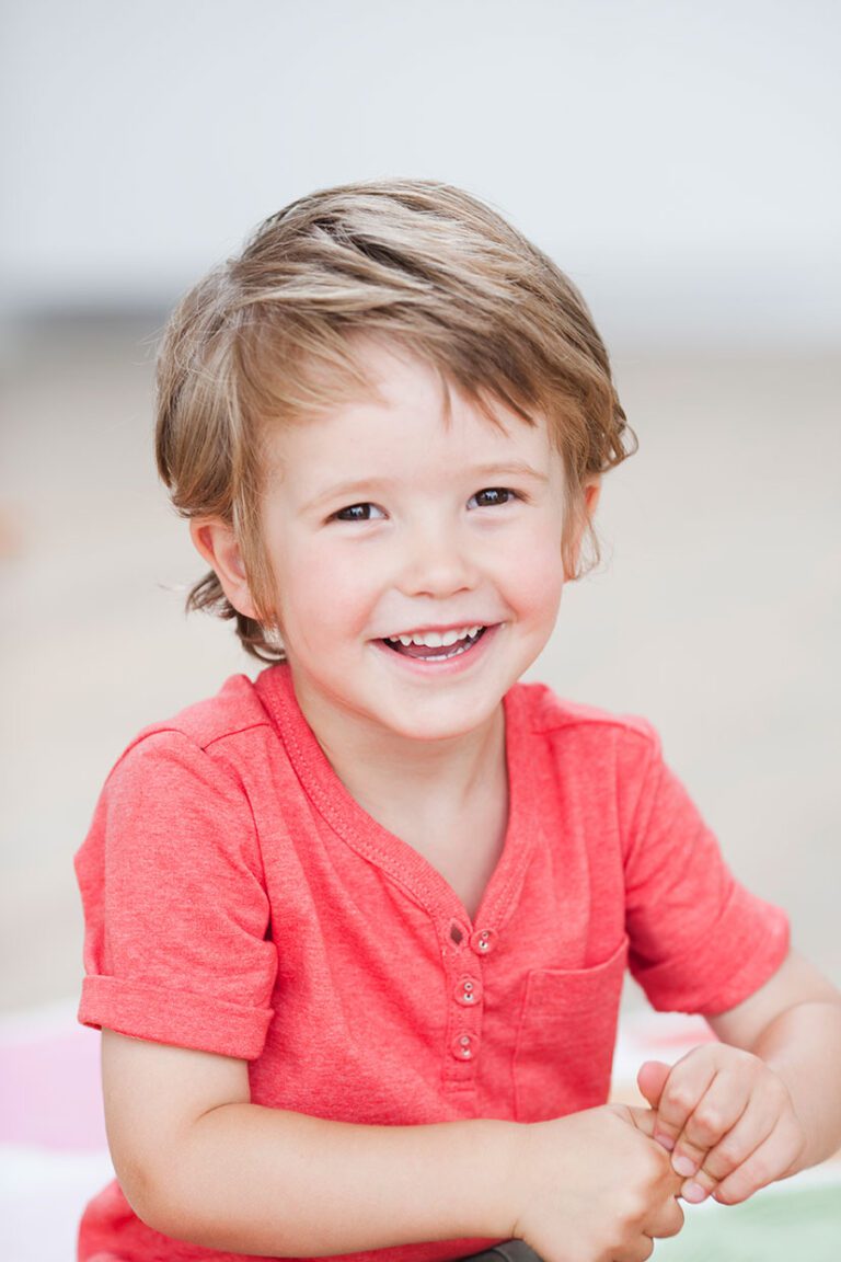 Young boy in preschool or kindergarten smiles for his school picture