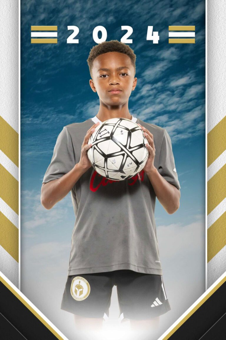 A youth soccer player poses with the soccer ball in a headshot