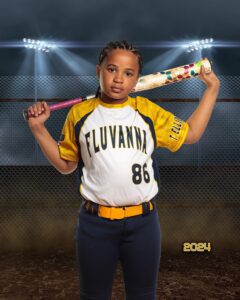 A young girl poses with a bat over her shoulders by Bob Kenward