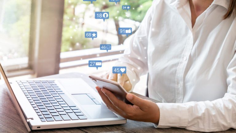 A woman checks her apps on her phone