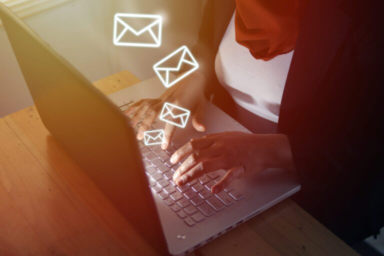 A person sending emails on a laptop