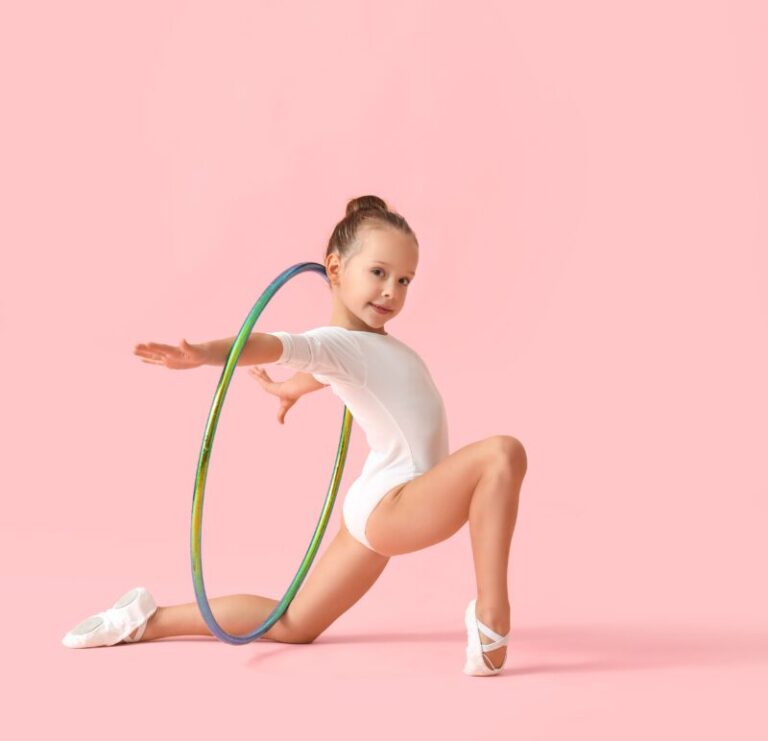 Little girl doing gymnastics with hula hoop on color background
