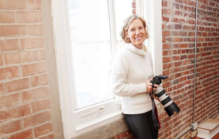 Heather Crowder holding a camera before a preschool shoot