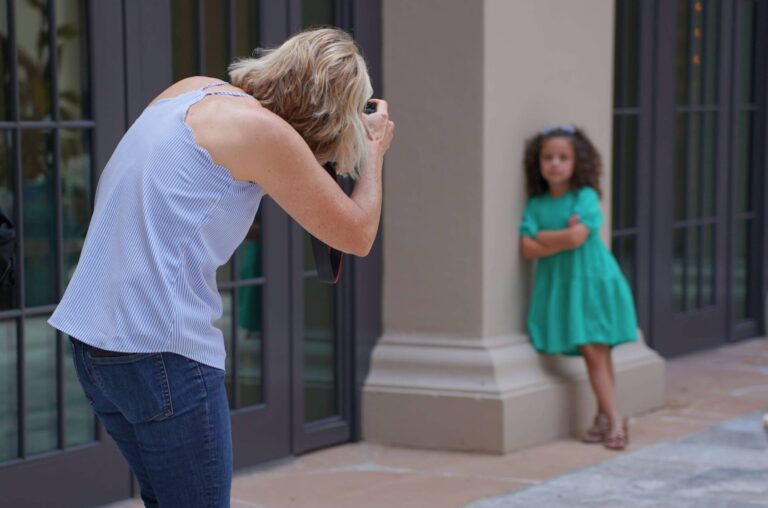 A photographer takes a photo of a child for school picture day