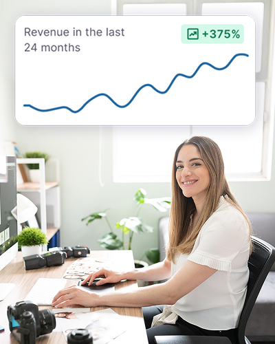 A woman looks calm sitting at her desk and showing growth