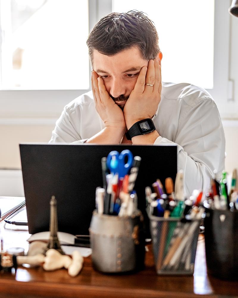 frustrated photographer sitting on his computer
