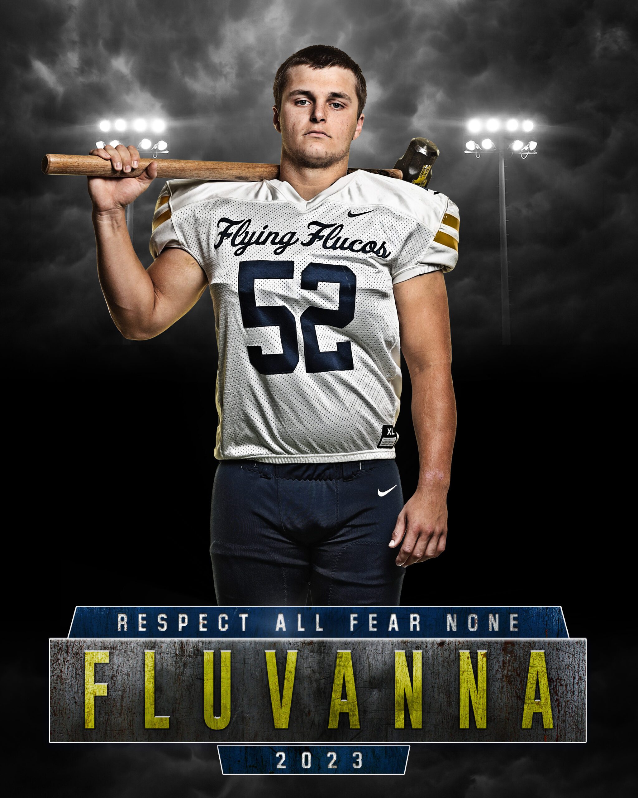 High school football player in uniform holding a hammer over his shoulder